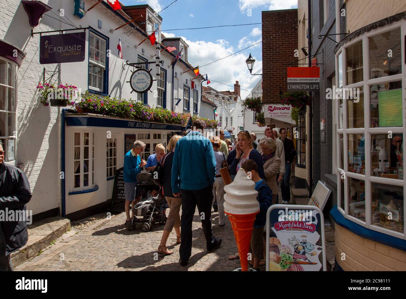 Lymington, UK 06/19/2010: A street view of Quay Street, New Forest National Park featuring tourists and local shops. This is a little  touristic town Stock Photo