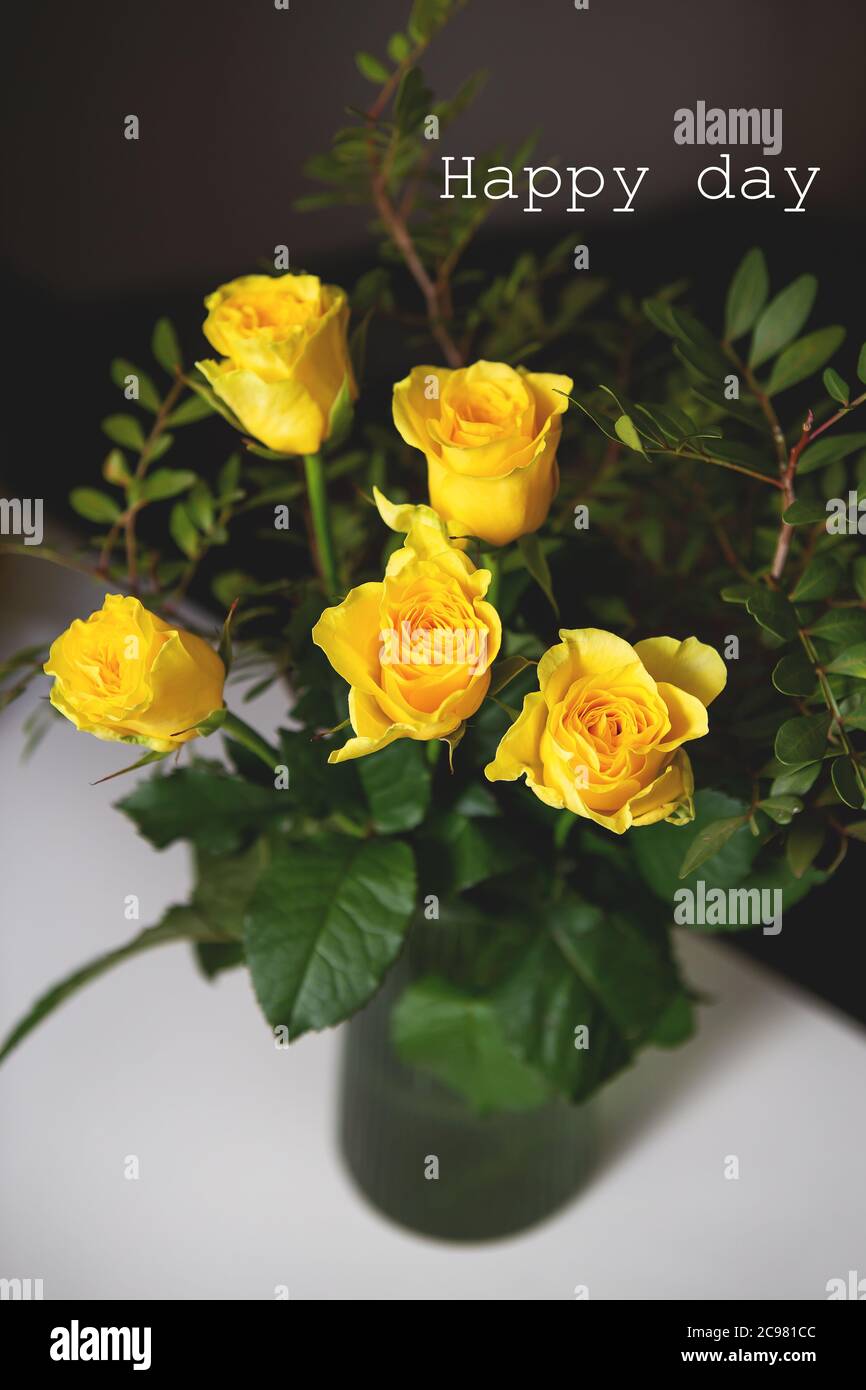 A very beautiful bouquet of yellow roses stands in a green vase ...