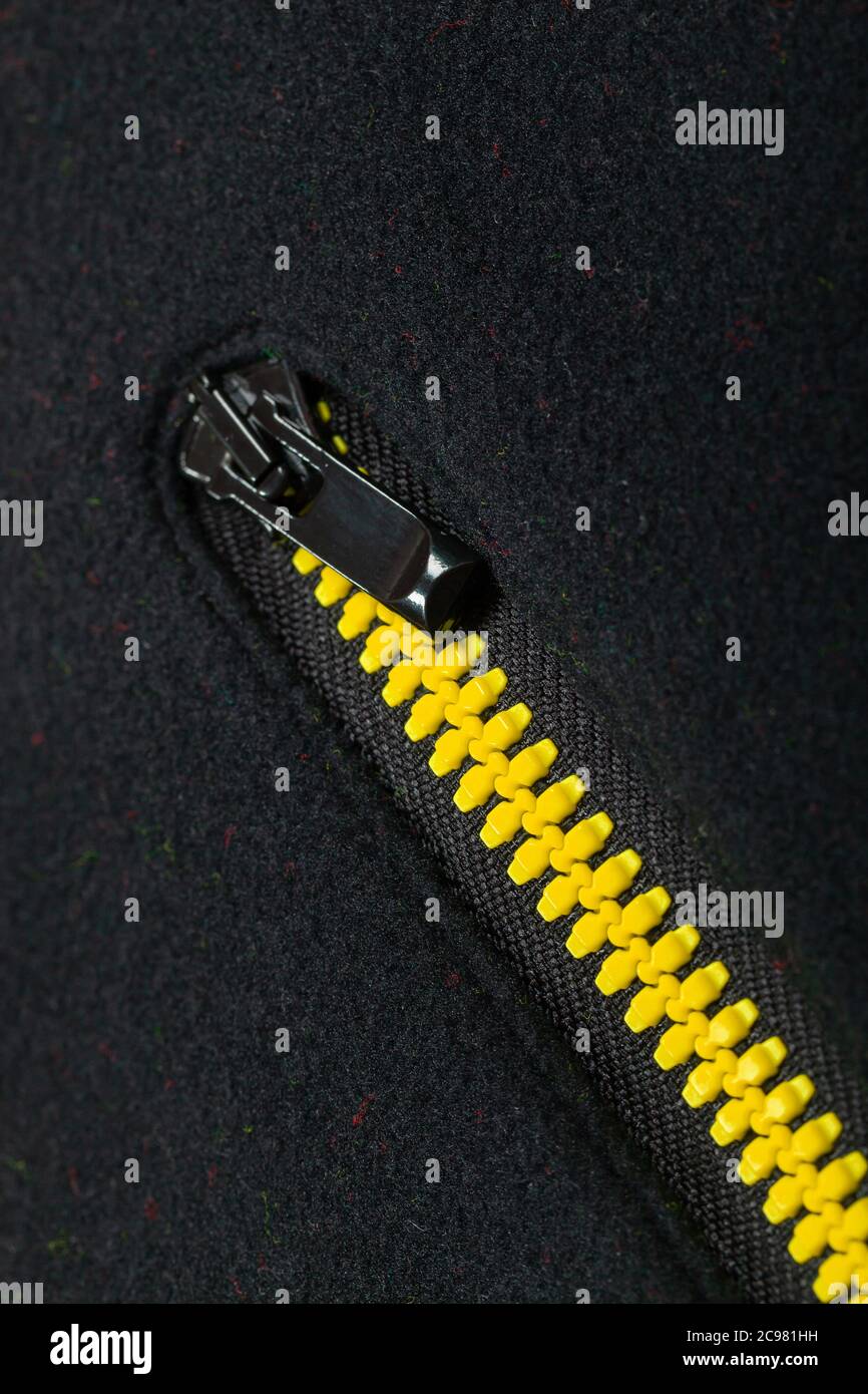 Yellow black pocket zipper, vertical close-up photo Stock Photo
