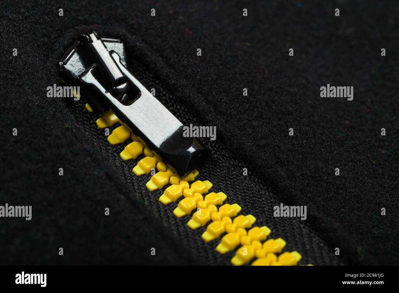 Yellow black zipper of a fleece jacket, close-up photo Stock Photo