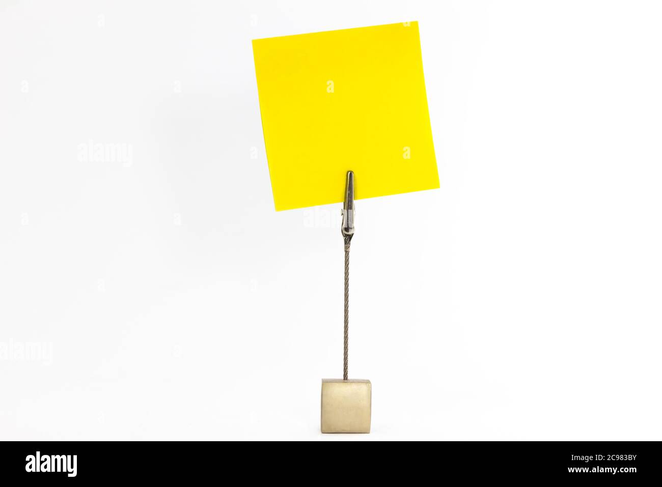 Close up shot of sticky notes held by a note holder isolated on a white background Stock Photo