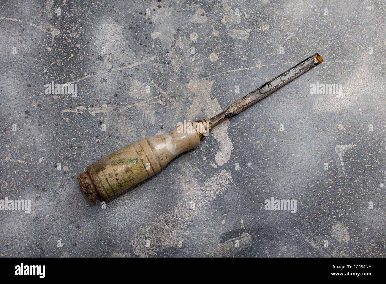 Chisel isolated on rustic background. Used tool with rubber handle. Instrument for carpenter. Stock Photo