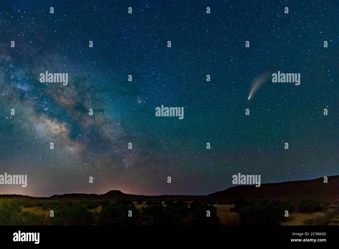 Comet Neowise in starry sky above desert, near Moab Utah, USA Stock Photo