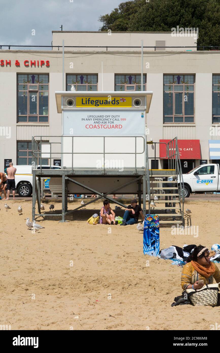 Unattended, closed, shut Lifeguard / Life Guard Station on a fairly busy Bournemouth beach with tourists, bathers and visitors on a sunny summer day. UK (120) Stock Photo