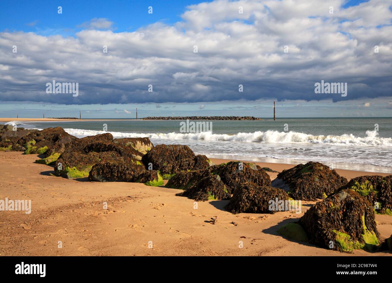 A view of the beach with rock armour and artificial reefs on the North Norfolk coast at Sea Palling, Norfolk, England, United Kingdom. Stock Photo