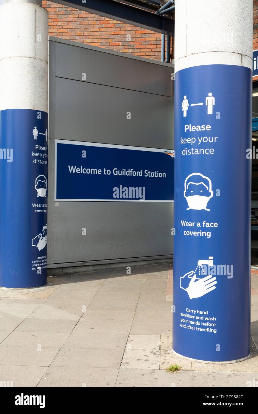 Entrance to Guildford train station showing COVID-19 signage, Surrey, England, 29 July 2020 Stock Photo