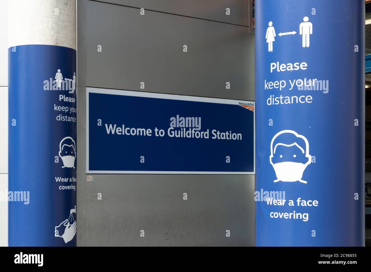 Entrance to Guildford train station showing COVID-19 signage, Surrey, England, 29 July 2020 Stock Photo