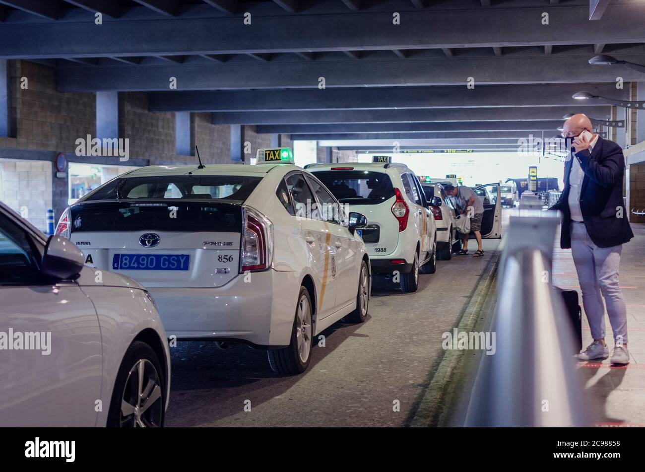 Taxi stand in the Seville Airport. Selective focus on a taxi. Blurry
