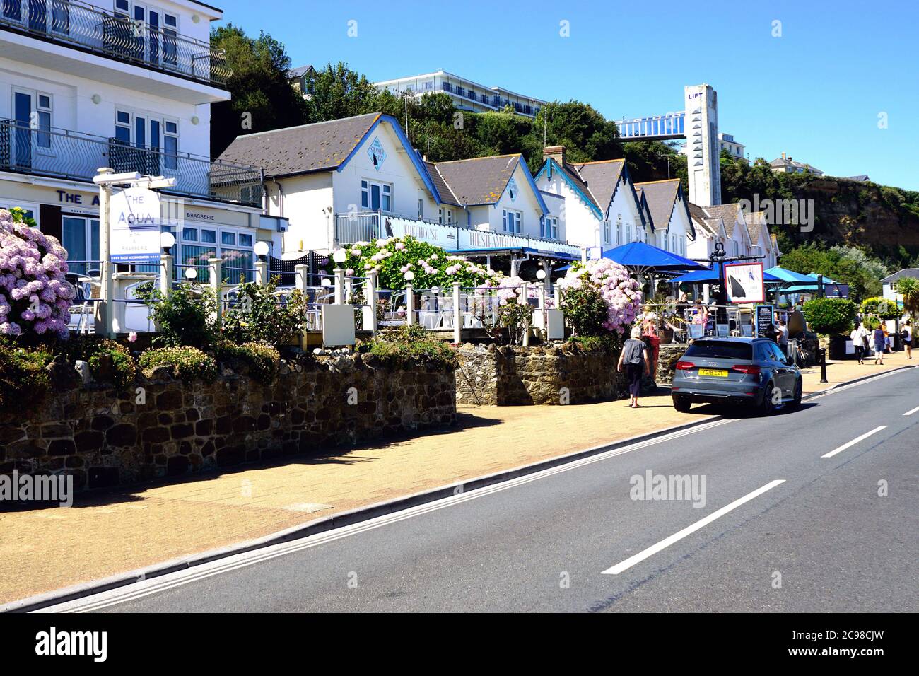 Shanklin, Isle of Wight, UK. July 18, 2020. Holidaymakers walking past seafront hotels and diners towards the cliff lift at Shanklin on the Isle of Wi Stock Photo