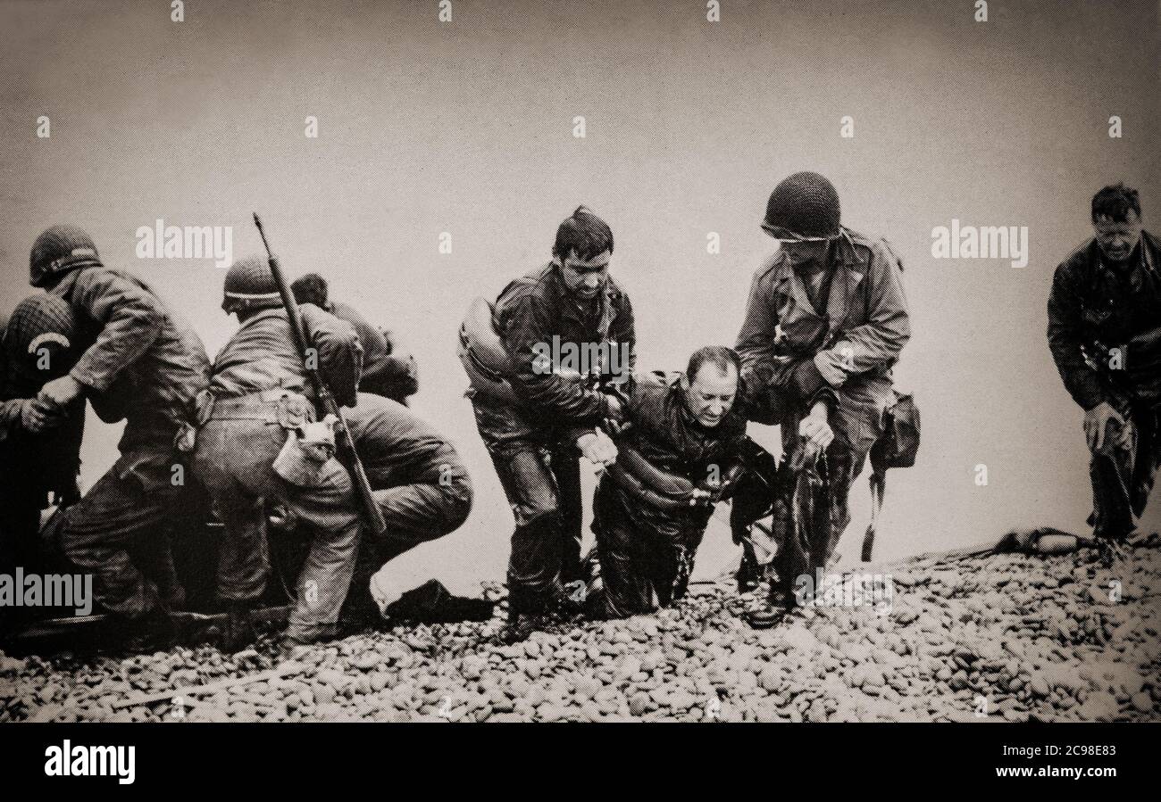American GIs struggle on to Utah Beach, code name for one of the five sectors of the Allied invasion of German-occupied France in the Normandy landings on June 6, 1944 (D-Day), during World War II. Stock Photo