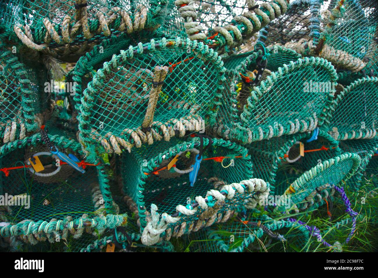 Lobster creels piled up at Holy Island harbour, Lindisfarne, Northumberland. Stock Photo