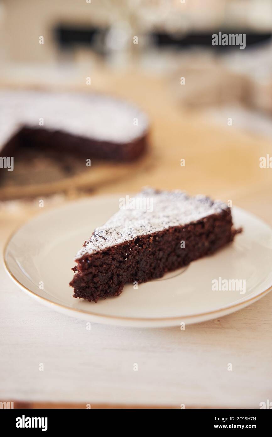 Delicious chocolate cake with cream on a white table presented with ...