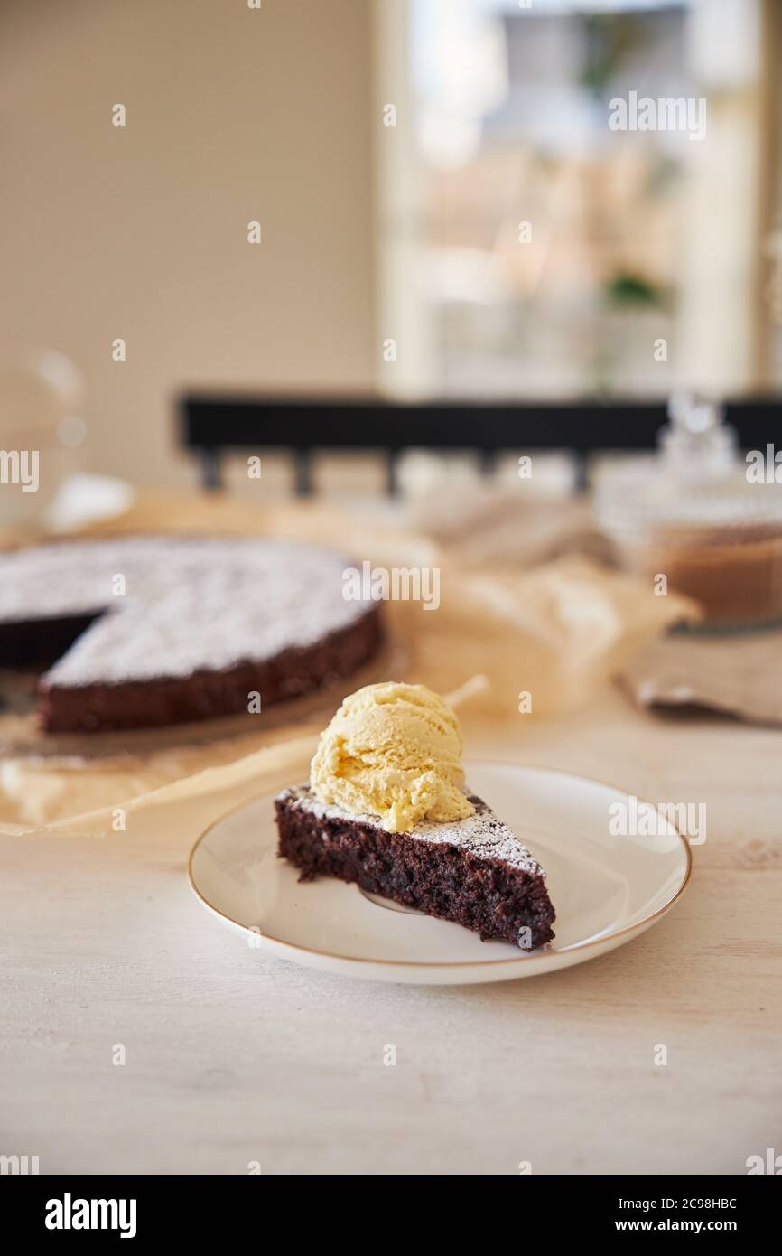Delicious chocolate cake with cream on a white table presented with ...