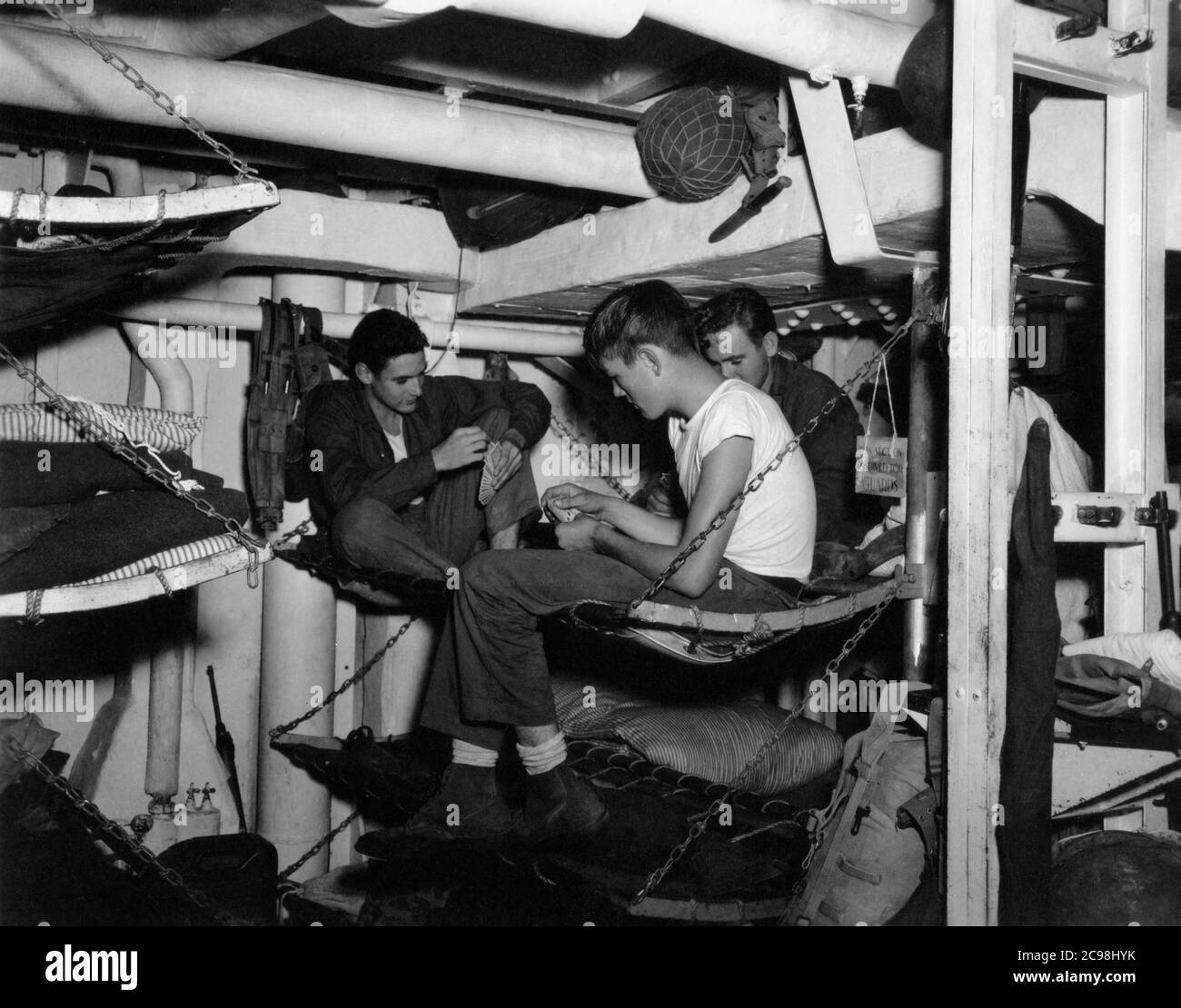 U.S. Navy enlisted men below decks on convoy OKS-14, July 1945. As the 75th anniversary of V-J Day approaches, The Consoli Collection has published four photo essays by U.S. Navy Lt. (j.g.) Joseph J. Consoli. The photos were taken between July and December 1945 in the Mariana Islands. They document U.S. Navy life before and after the Japanese surrender. Stock Photo