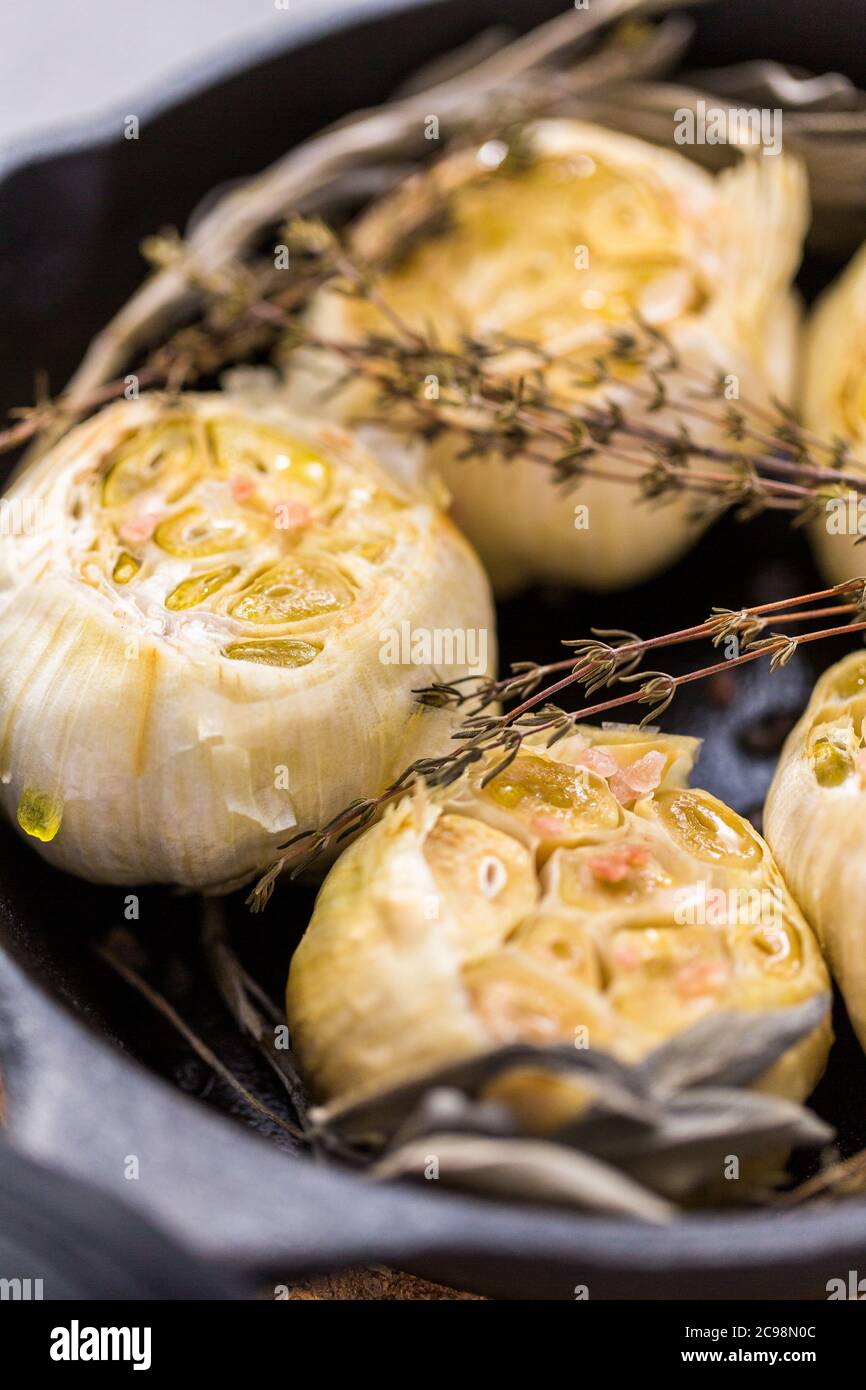 Roasted garlic spread recipe made with spices in cast iron skillet