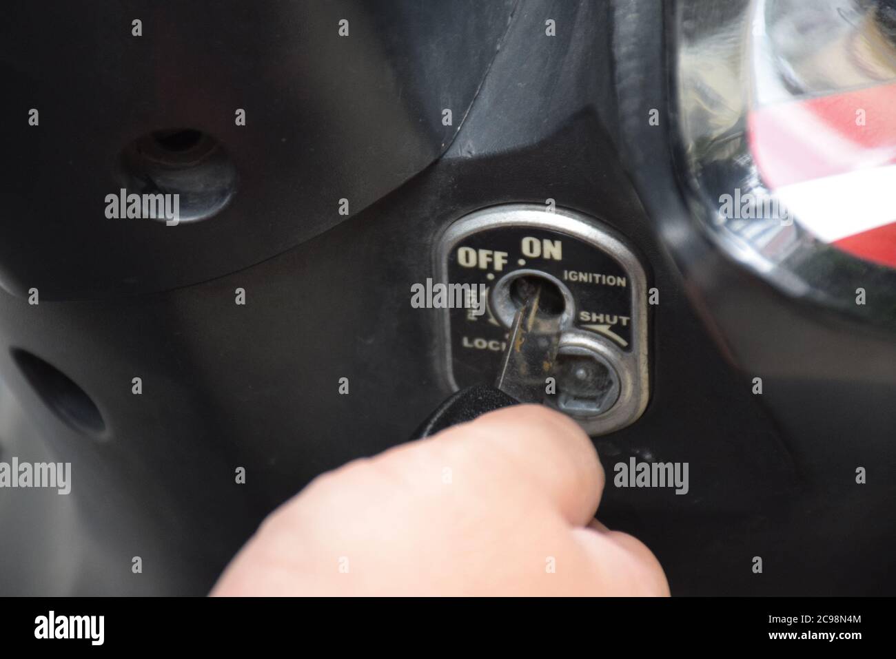 Hand enter key to start the engine of the motorcycle Stock Photo - Alamy