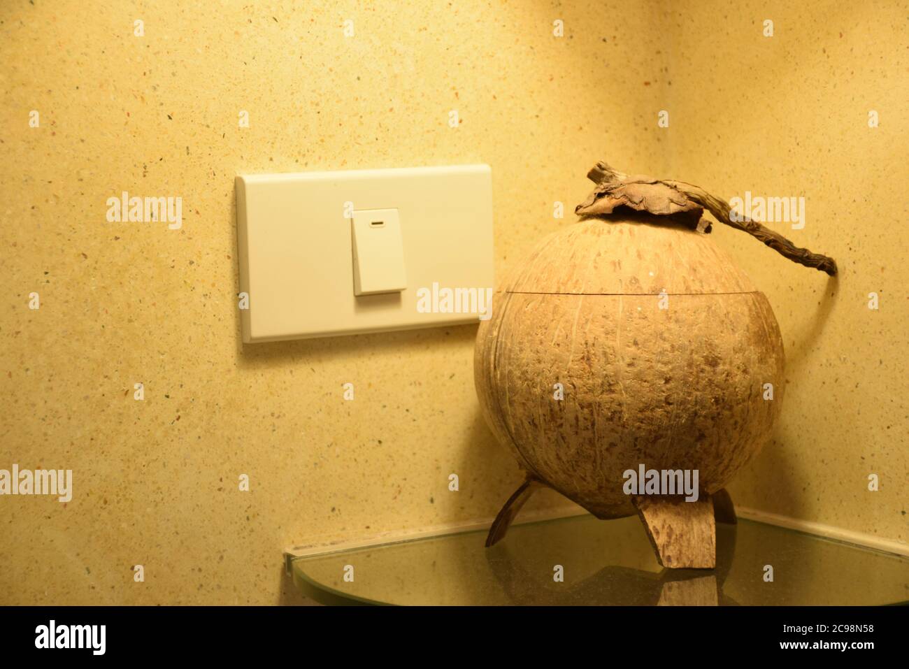 lighting Switch and Recycle a Coconut shell Bucket in Bathroom Stock Photo