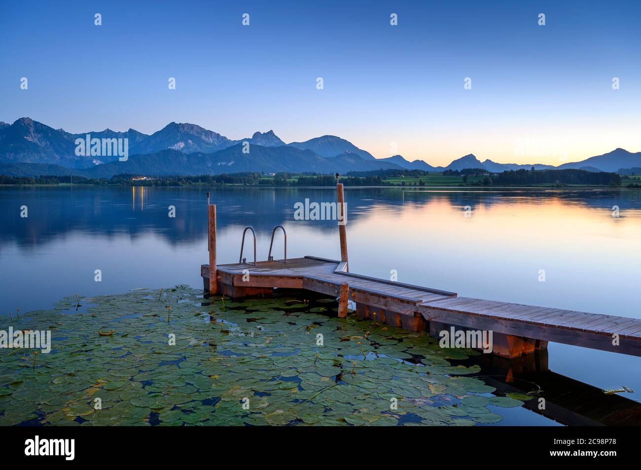 Wooden footbridge at Hopfensee with the Tannheim mountains in the background, Allgäu, Schwaben, Bavaria, Germany Stock Photo