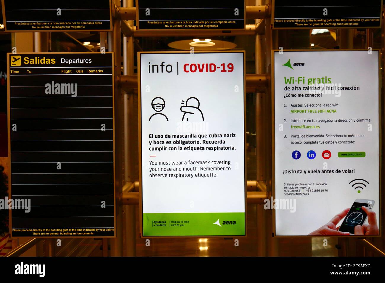 28th July 2020, Barajas Airport, Madrid, Spain: A Covid-19 information sign and empty flight departure board in the departure lounge area of the Terminal 4S building of Barajas Airport. Reduced numbers of flights are now operating between European countries after the lockdown to control the covid-19 coronavirus, and governments have put a system of air bridges in place to facilitate travel and tourism. Spain has seen a number of new outbreaks in recent days, prompting the UK government to announce that people returning to the UK from Spain should quarantine for 14 days on arrival. Stock Photo