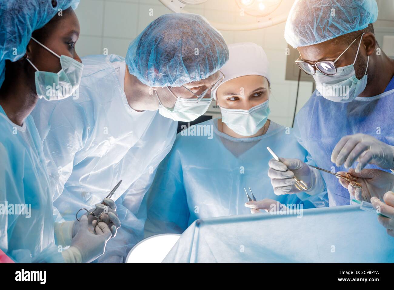 hardworking team of surgeons at work in operating room.profession, job, occupation concept Stock Photo