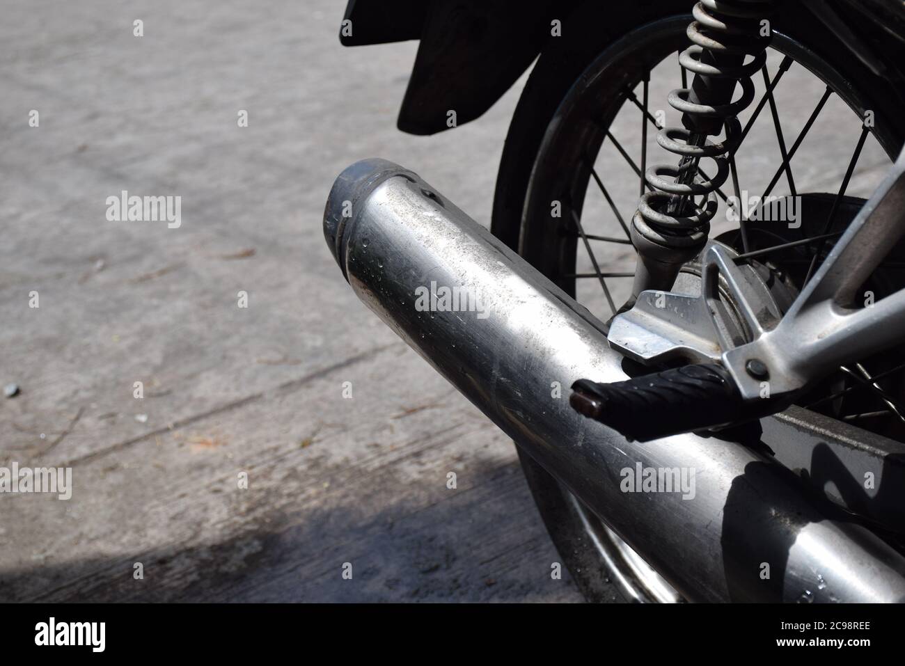 Motorcycle exhaust on Road Stock Photo