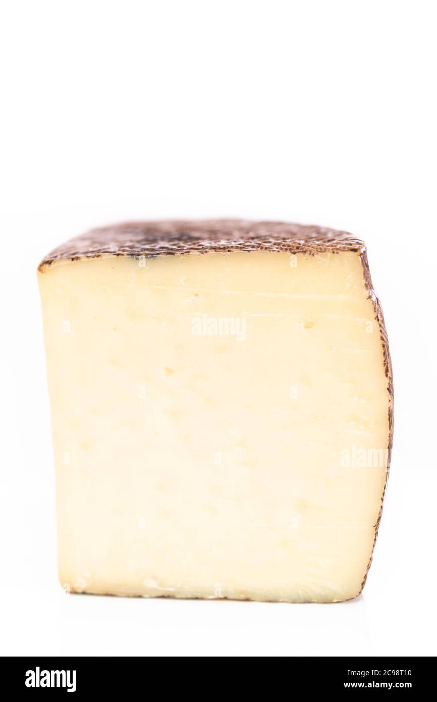 Large slice of aged Manchego cheese on a white background Stock Photo ...