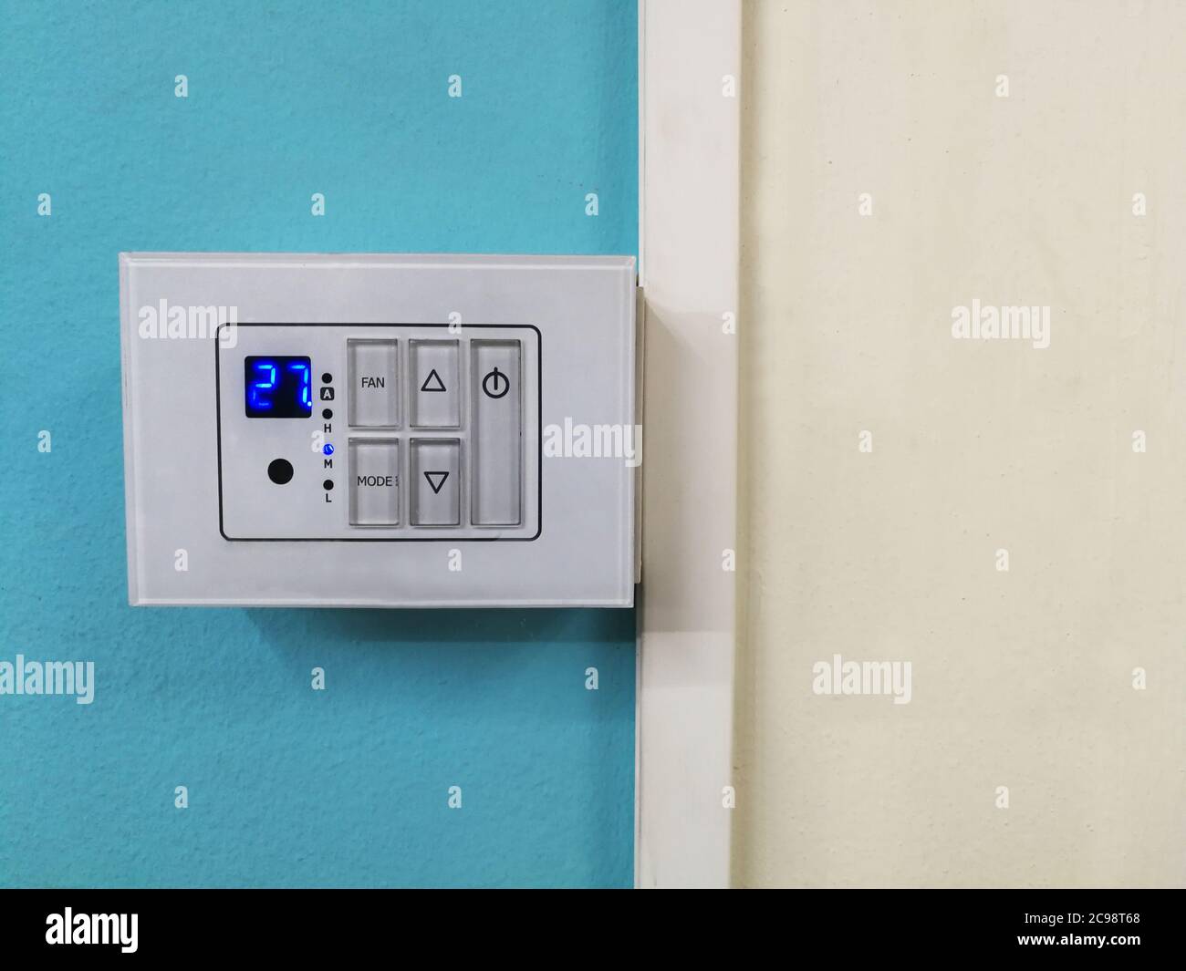 Room Thermostats on blue and white background. Stock Photo