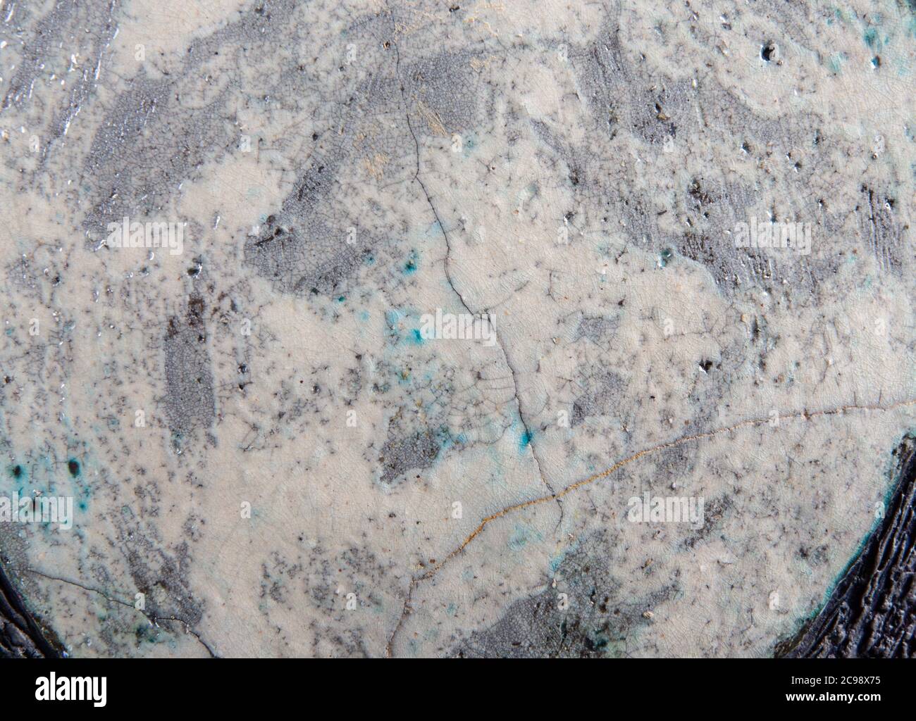 A crack pattern in the glaze of a ceramic plate., close up Stock Photo