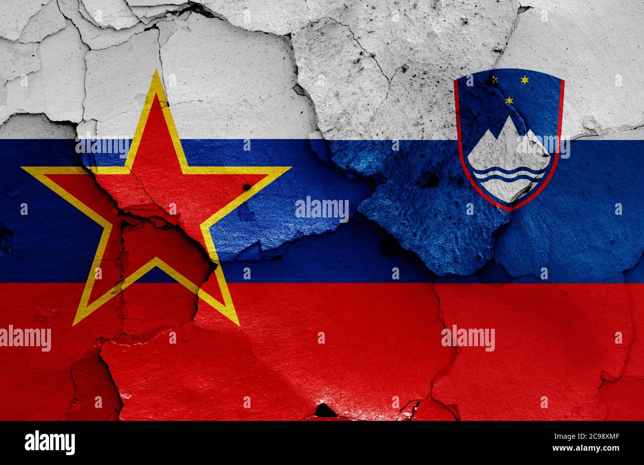 historical flag of Socialist Republic of Slovenia and today Slovenia flag on cracked wall Stock Photo
