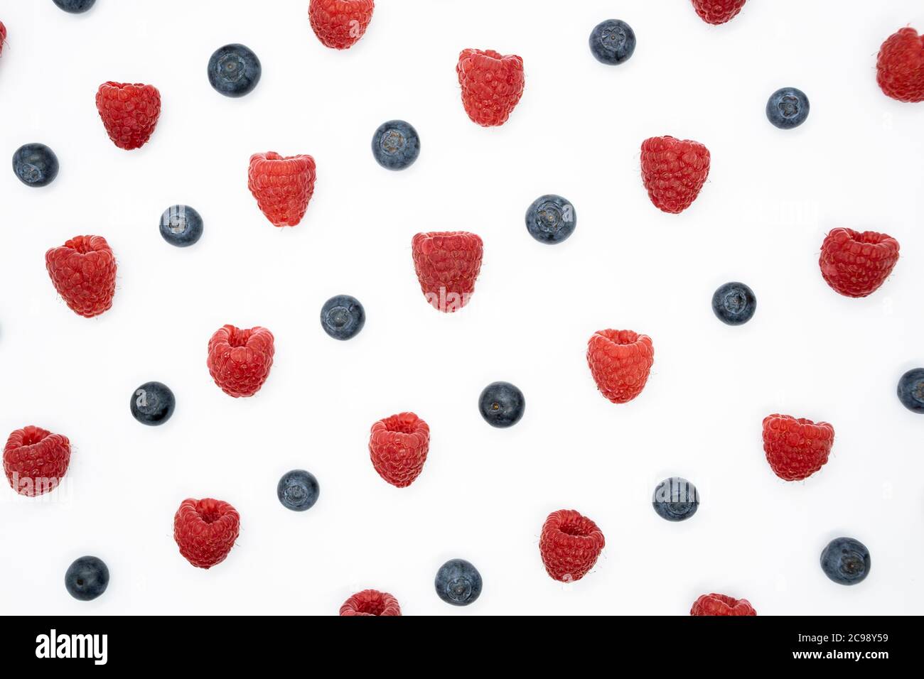 Creative layout with blueberry and raspberry isolated on the white background. Top view. Flat lay pattern. Stock Photo
