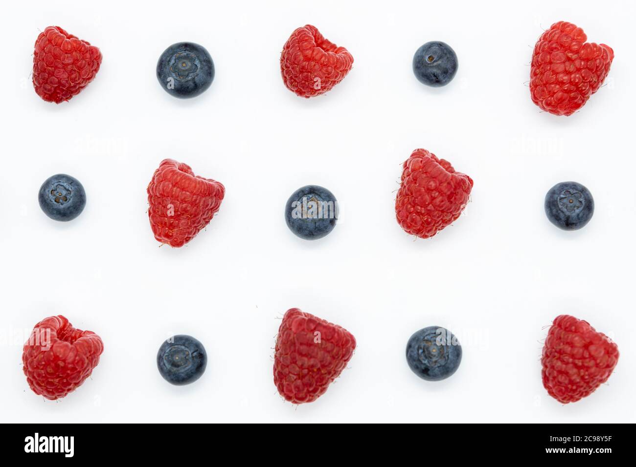 Creative layout with blueberry and raspberry isolated on the white background. Top view. Flat lay pattern. Stock Photo
