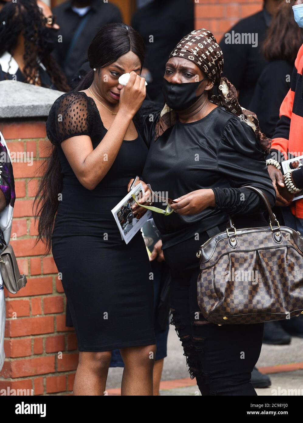 RETRANSMITTING CORRECTING NAME OF SISTER FROM KHAJI TO KHAFI CORRECT CAPTION BELOW Khafi Kareem (left), the sister of Alexander Kareem, after his funeral service at the Church of Holy Ghost and St Stephens in London. Stock Photo