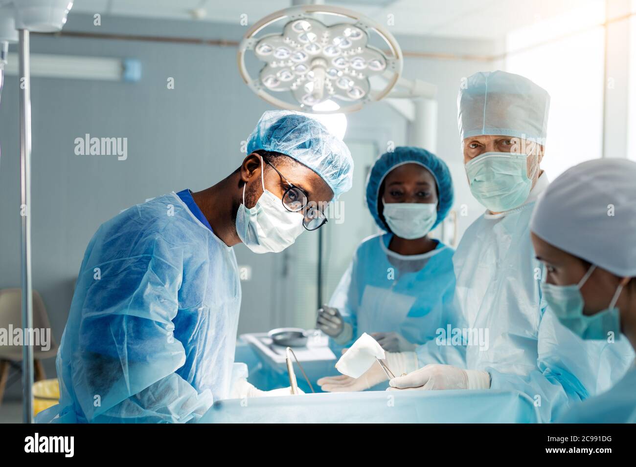 diverse assistants and urnses performing invasive surgery in the clinic. close up photo Stock Photo