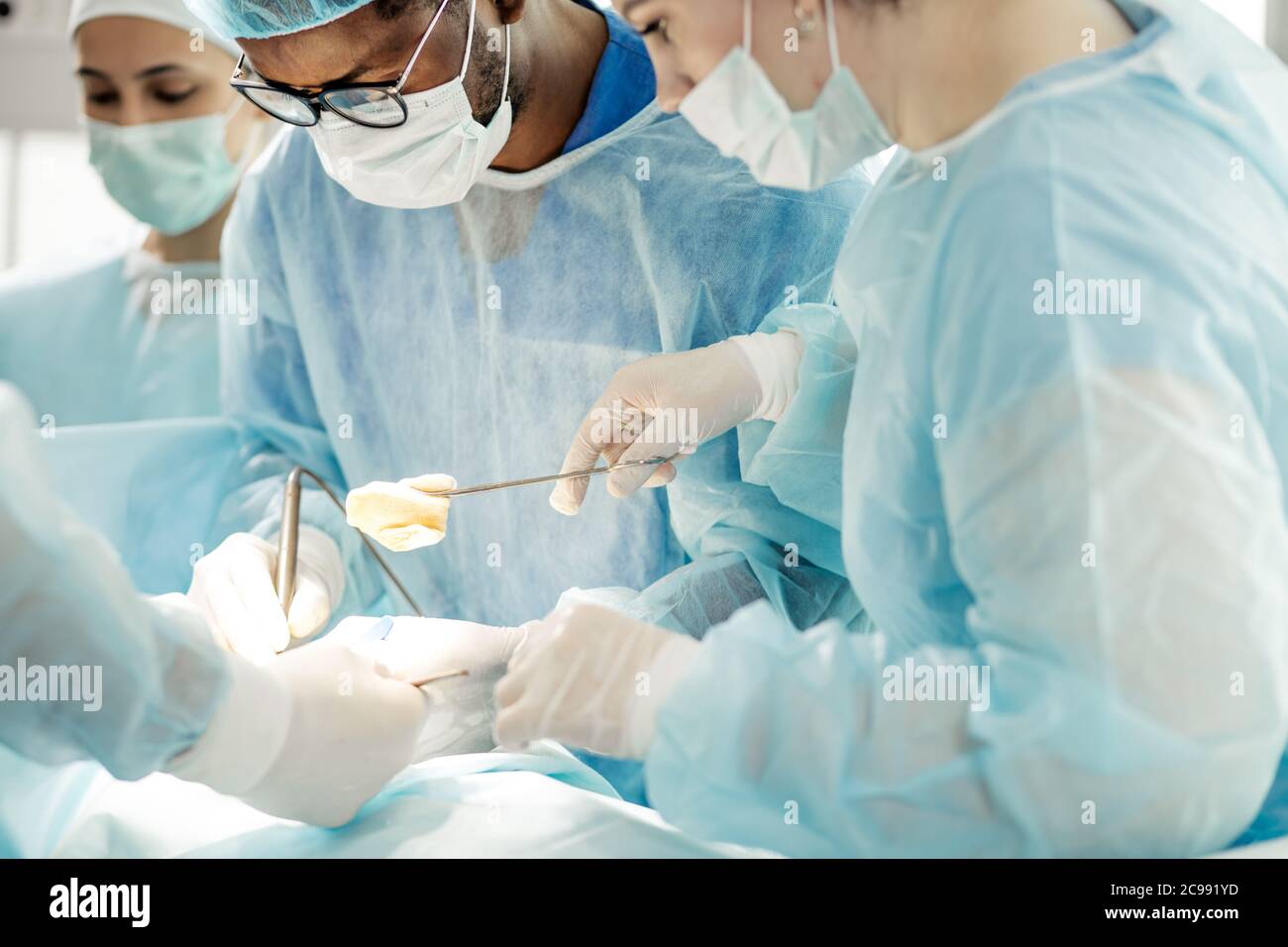 team of doctors and nurses disinfect the wound in the operating room