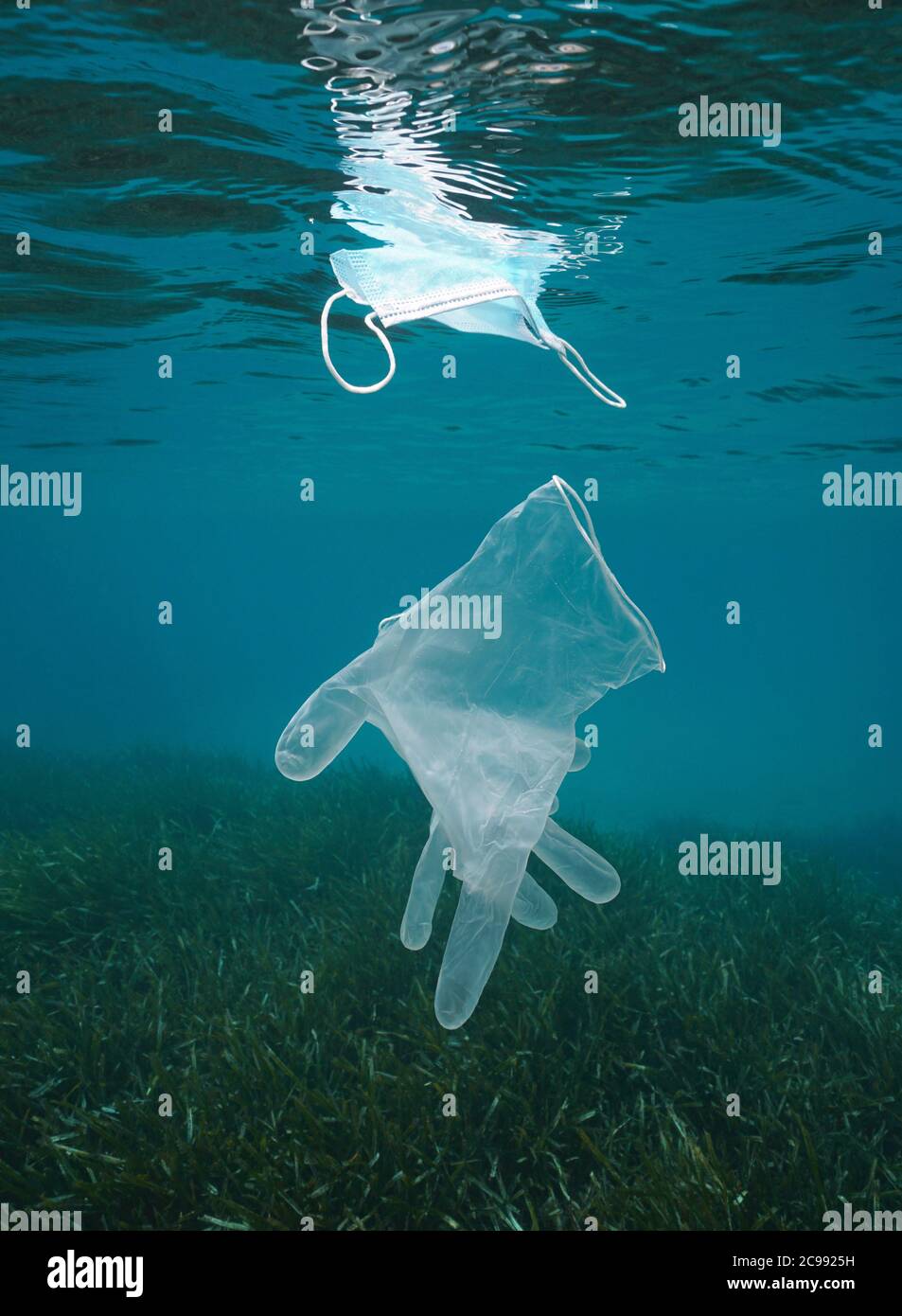 Plastic waste pollution underwater in the sea, glove and face mask, coronavirus COVID-19 pandemic, Mediterranean sea Stock Photo