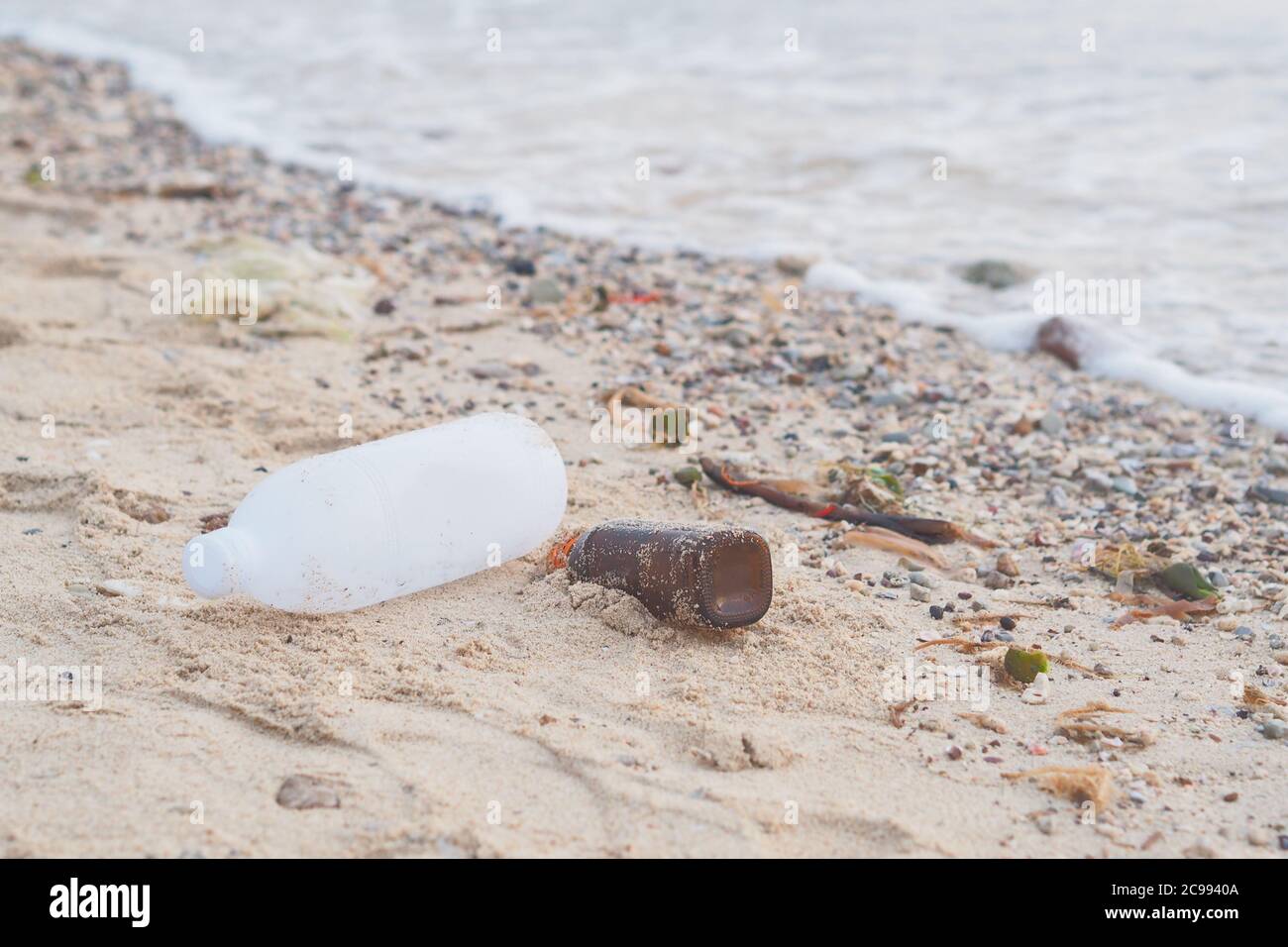 Soft focus on Waste plastic bottles and other types of plastic waste on beach. Stock Photo