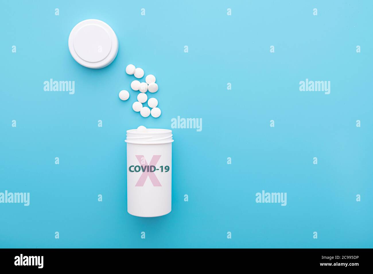 Anti COVID - 19 pills in white plastic bottle on blue background, anti virus pills, drugs, concept medical picture. Stock Photo