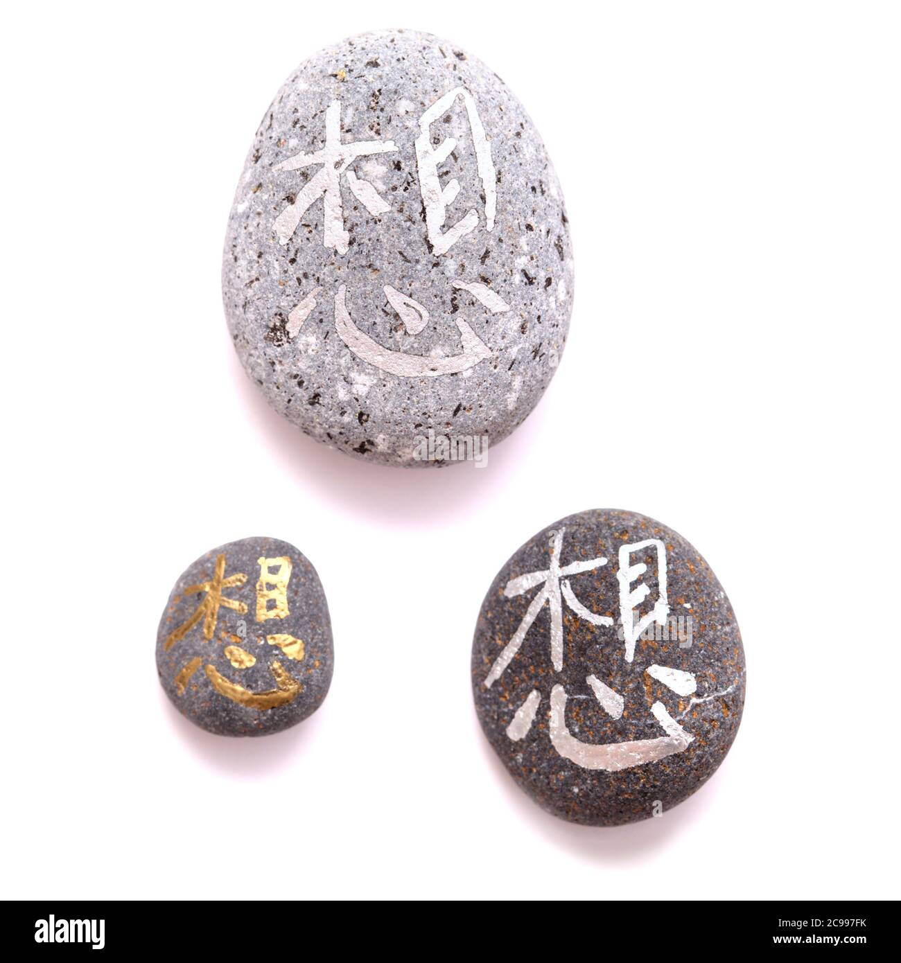 Chinese Or Japanese Symbol Meaning Think Or Miss Painted On Volcanic Pebbles In Metallic Paint Stock Photo Alamy