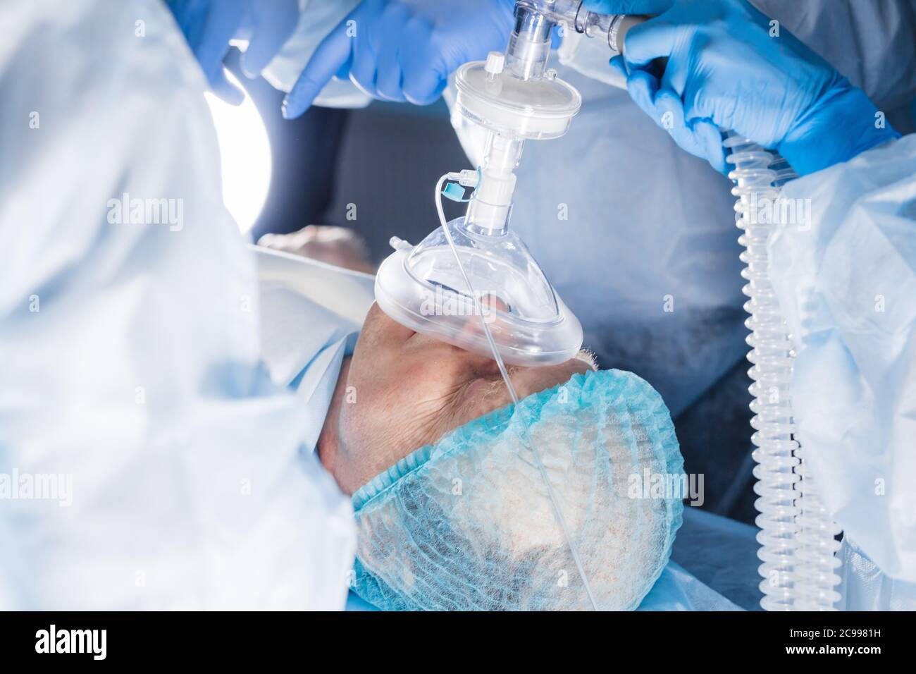 anesthesiologist gives the mask inhalation anesthesia to a male