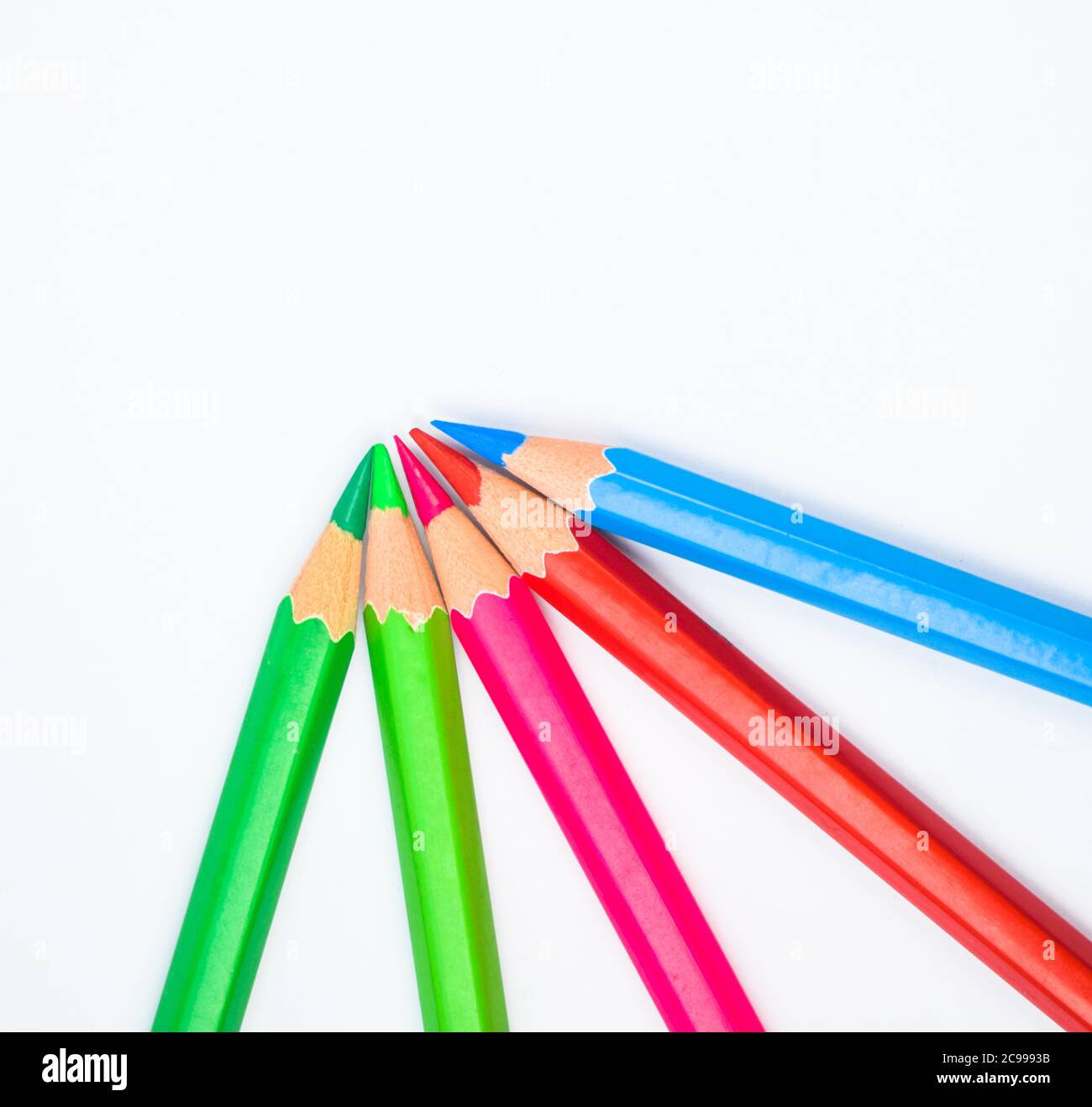 Pattern made with five different colored wood pencil crayons on a paper background Stock Photo