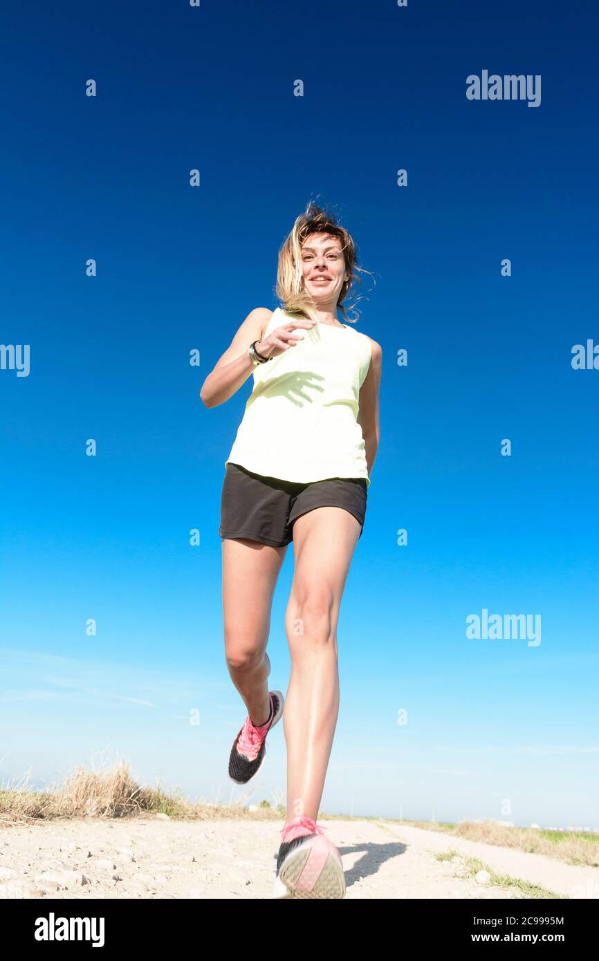 Woman running towards sun hi-res stock photography and images - Alamy