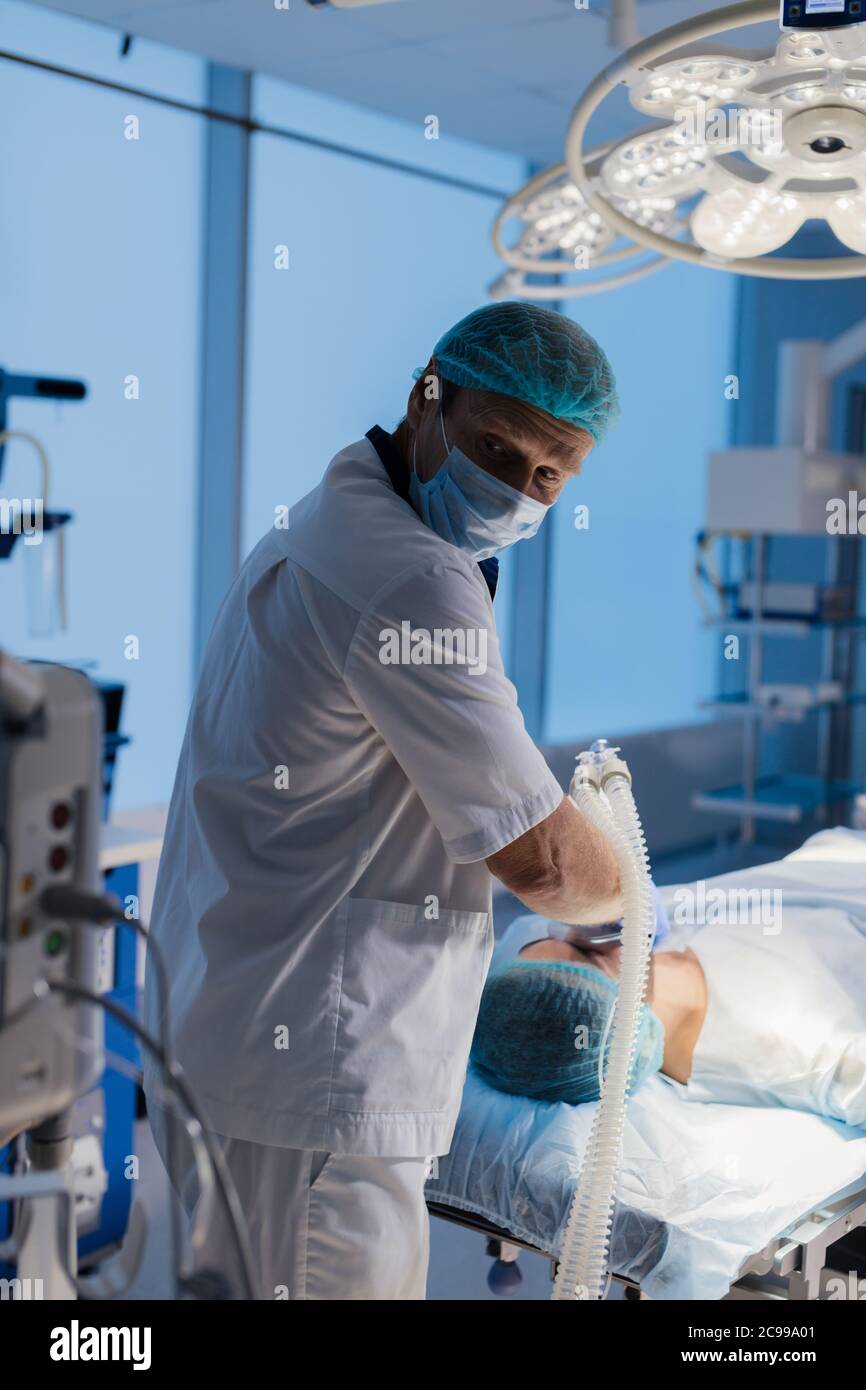 Medical team preparing equipment for surgery in operation room. Stock Photo