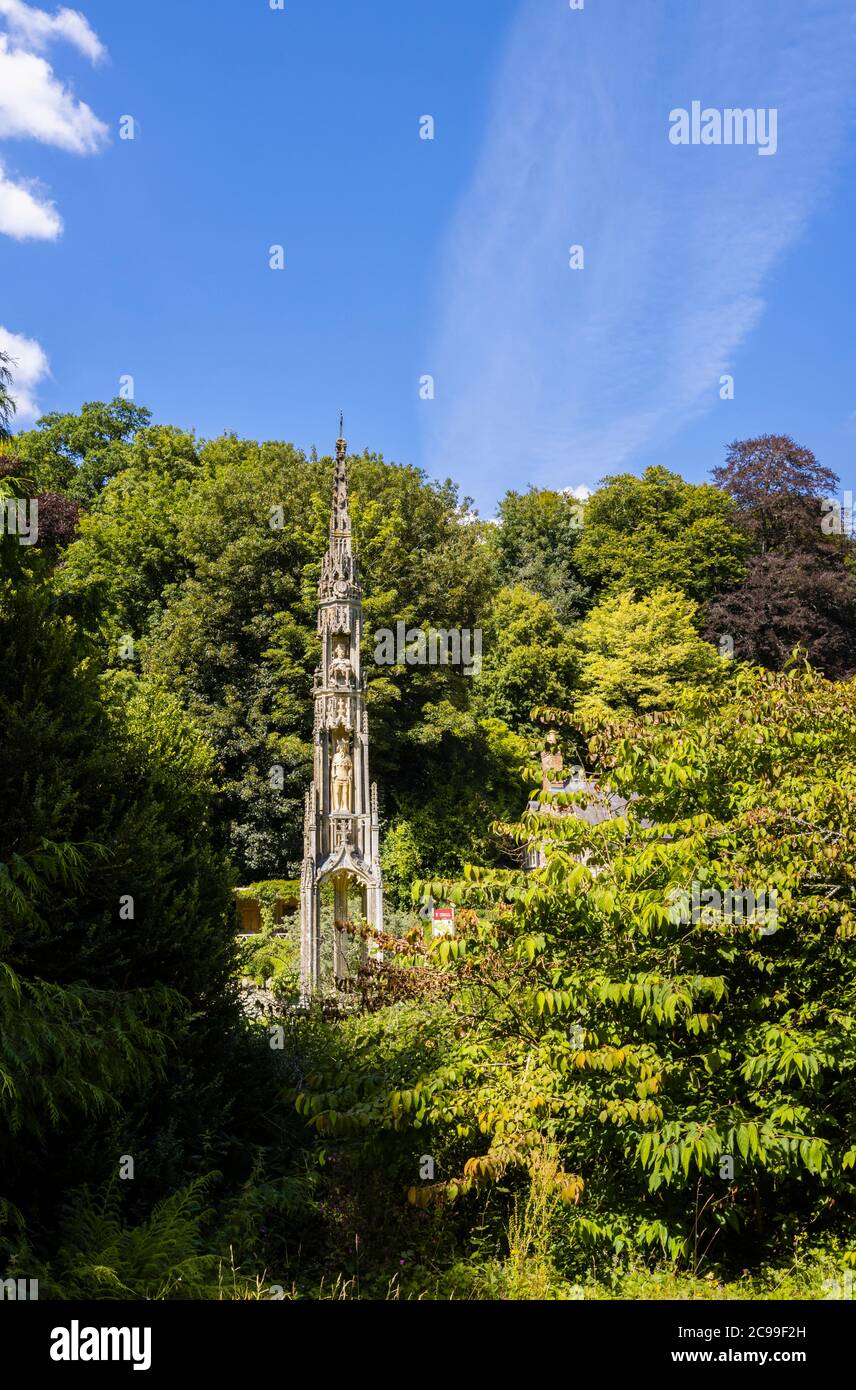 The historic Bristol High Cross at Stourhead, Stourton, Wiltshire, south-west England viewed through trees Stock Photo