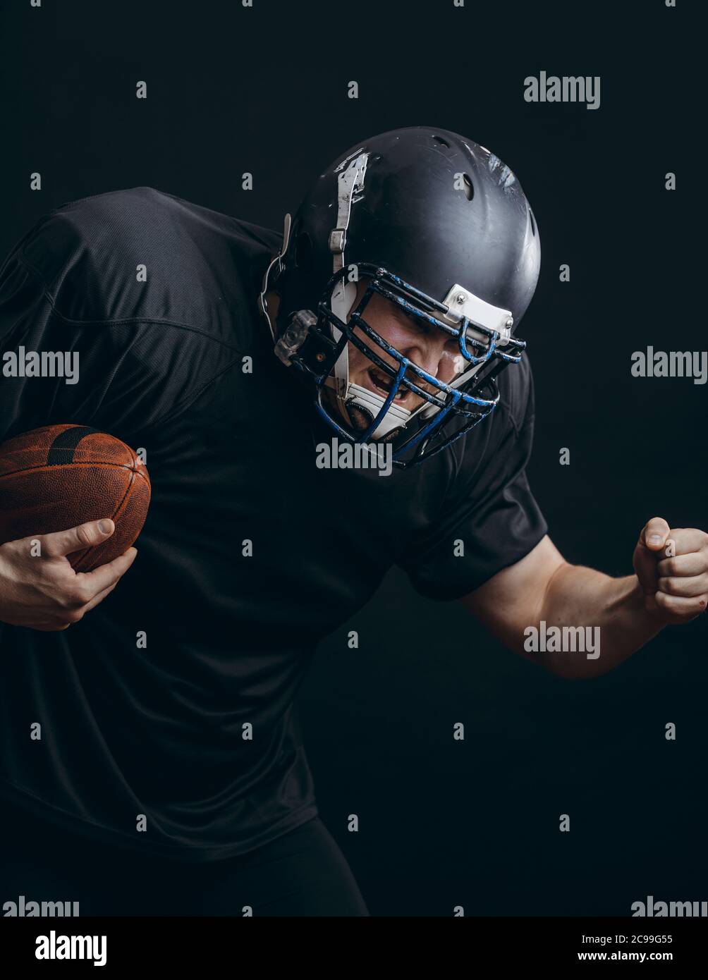 American football caucasian player wearing black uniform with ...