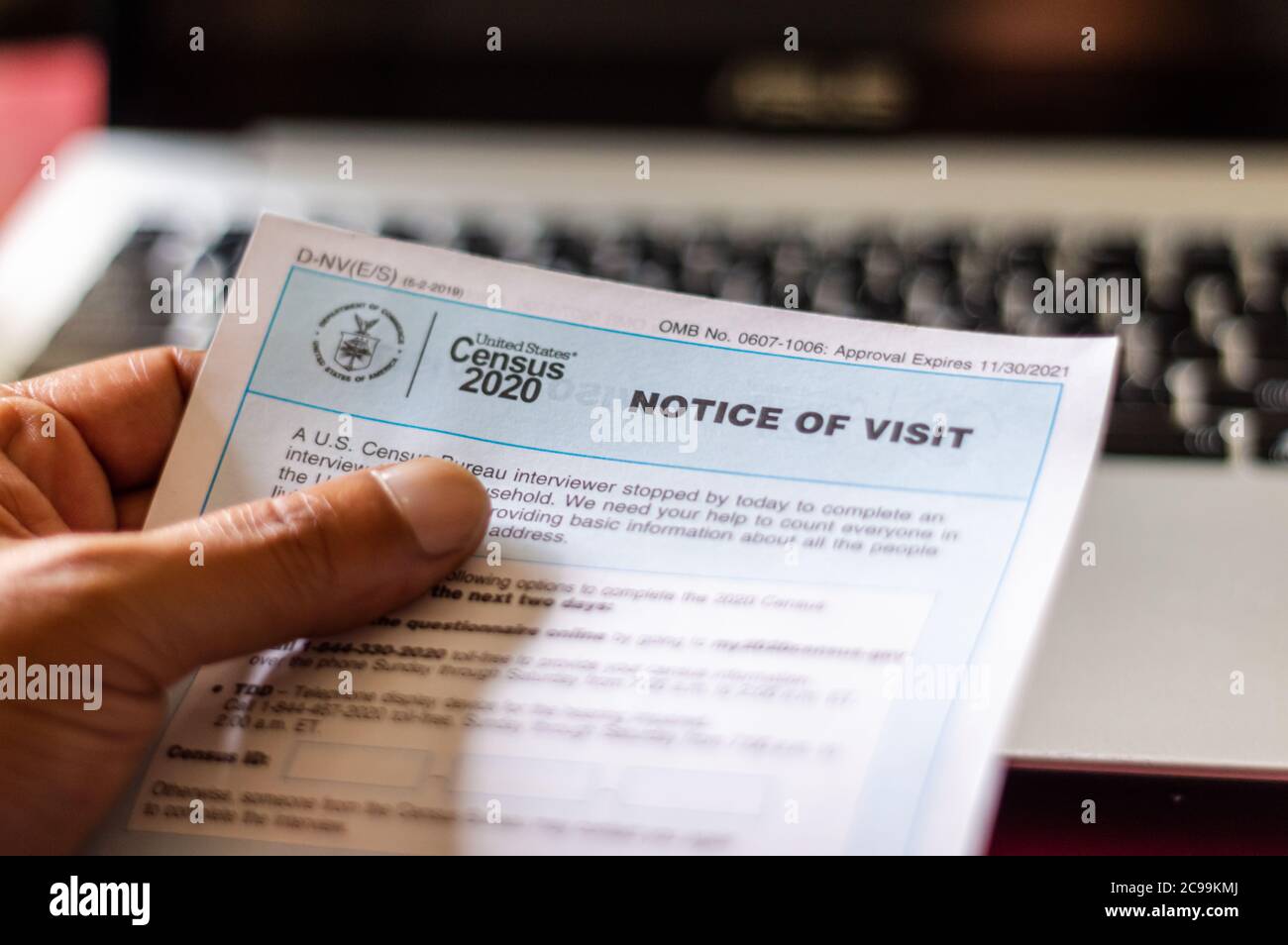 A hand holding a Notice of Visit from the US Census Bureau. Chicago, Illinois-July 29, 2020 Stock Photo