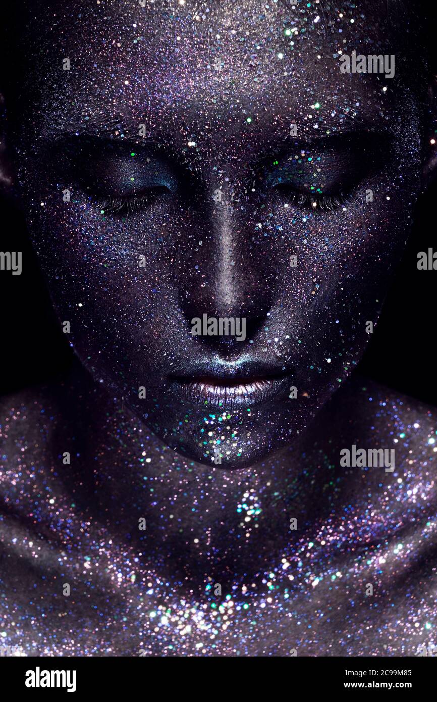 Beautiful girl with art space makeup on her face and body. Glitter Face