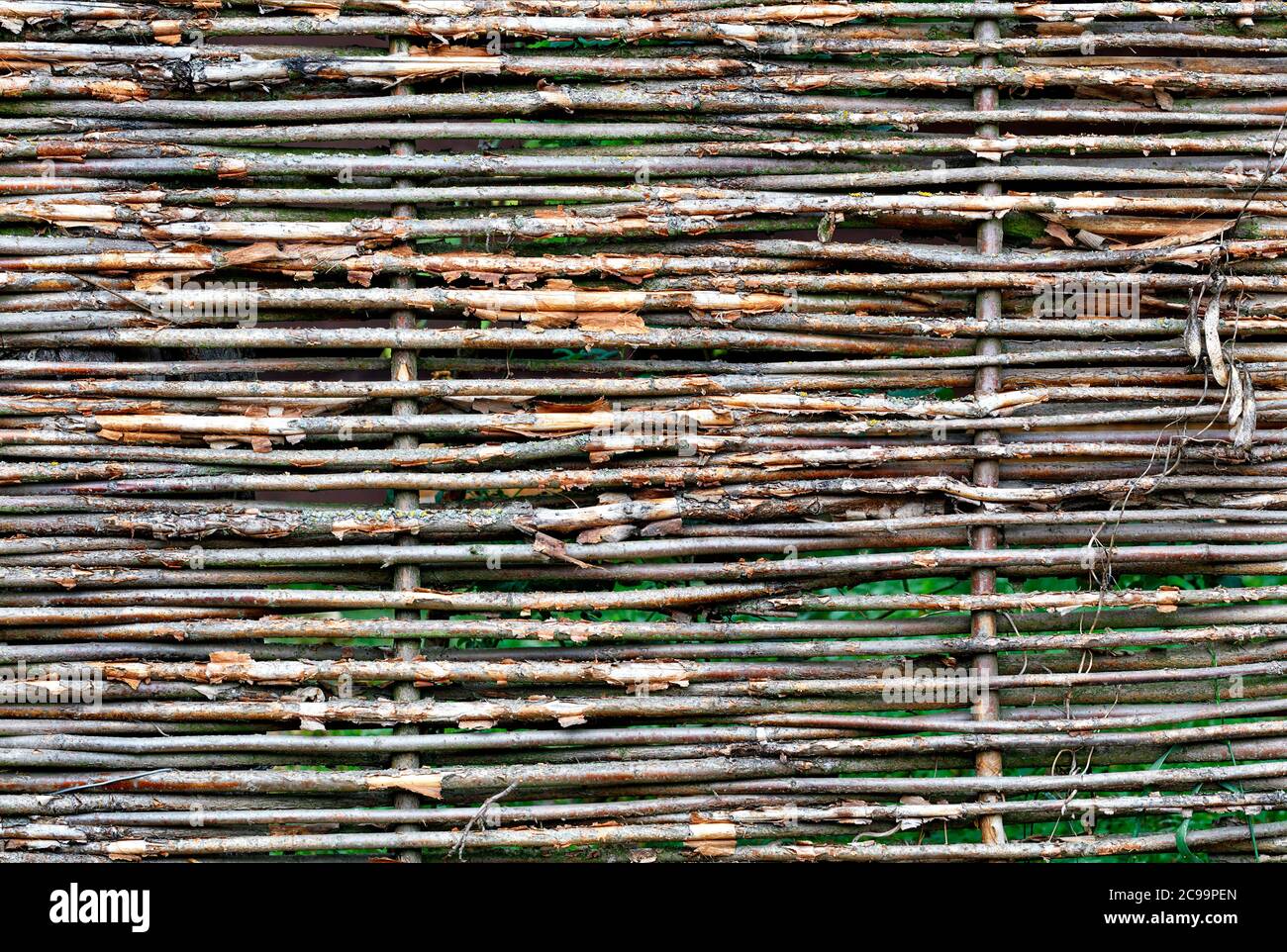 Texture and background of a wicker fence made of old weathered branches, copy space. Stock Photo