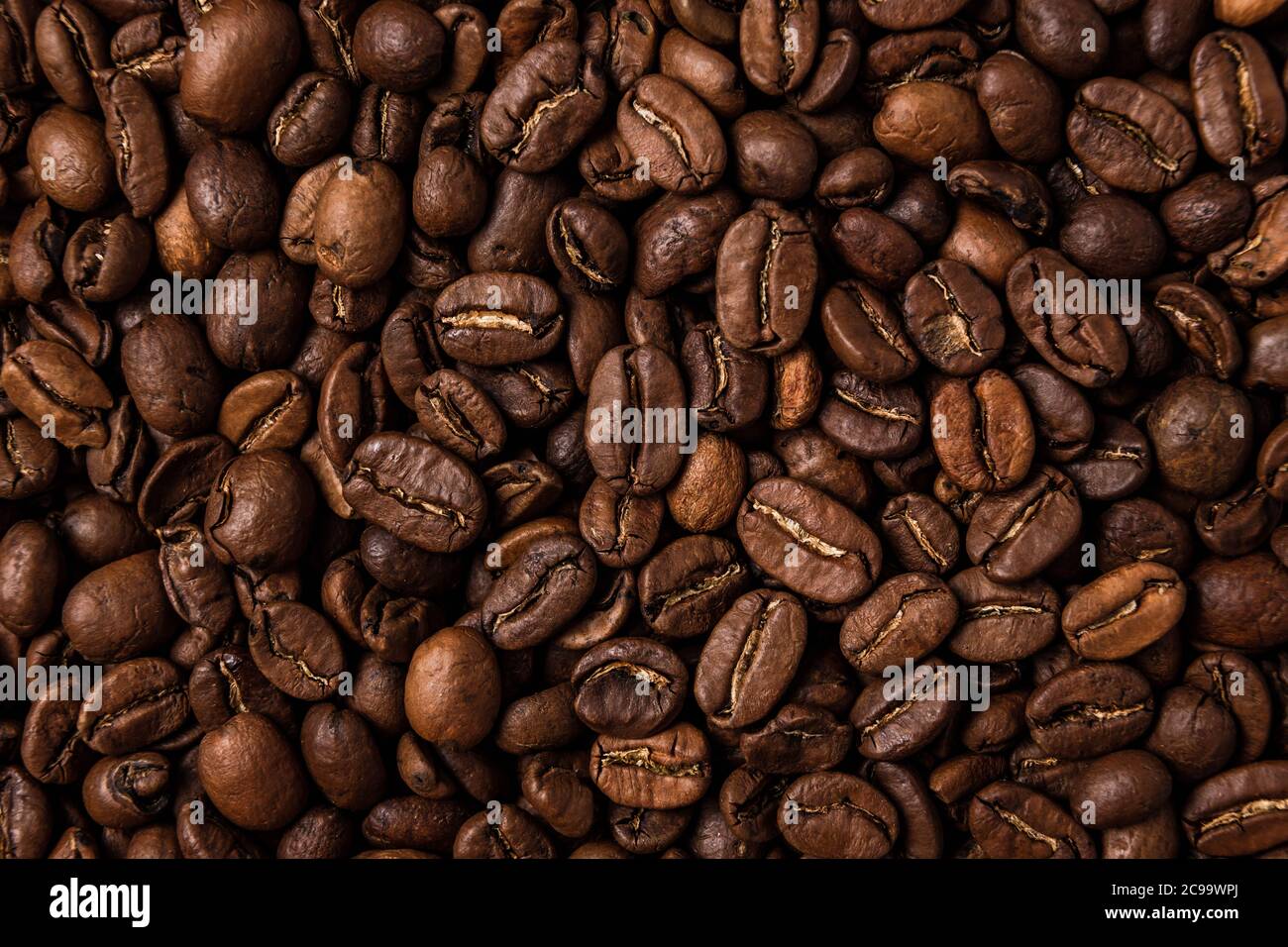 Roasted coffee beans on the table, macro Stock Photo - Alamy