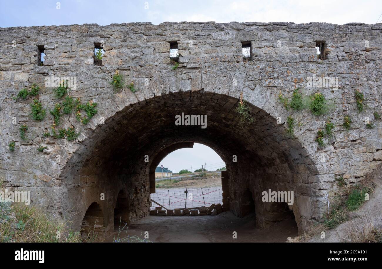 Arch entrance to the fortress of Yenikale on the shore of the Kerch Strait.Fortress wall. Stock Photo