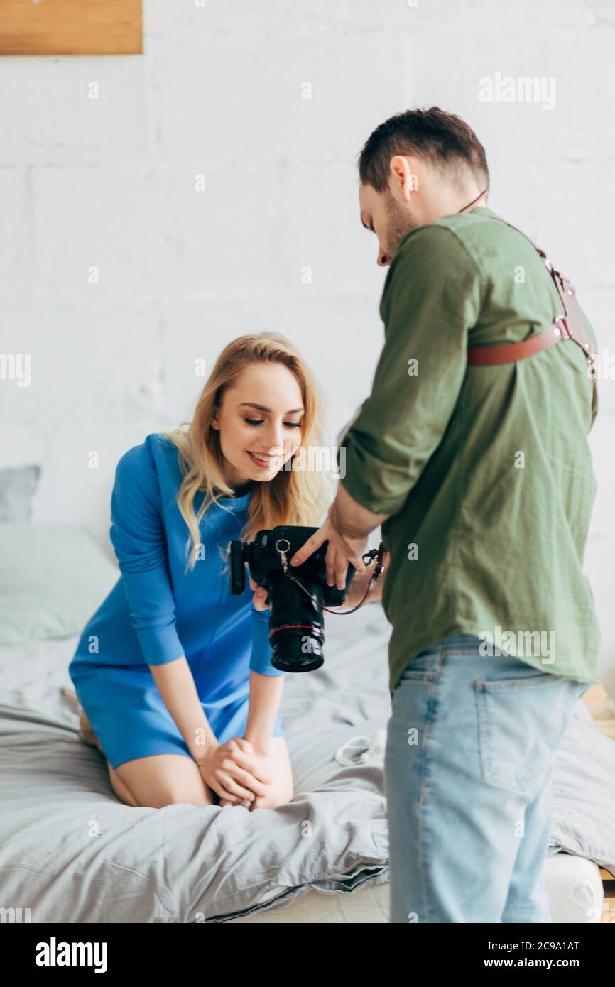 happy girl is looking at her photos after working with an amateur  photographer , close up photo Stock Photo - Alamy